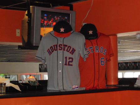 The 2013 Houston grey road uniform (L) and the Friday night home orange jersey.