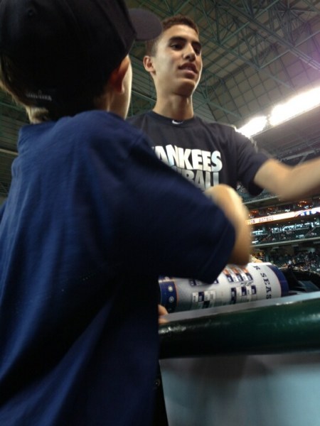Little Elijah Thompson (back turned) gets ready to receive the surprise of his young lifetime from Mariano Rivera.