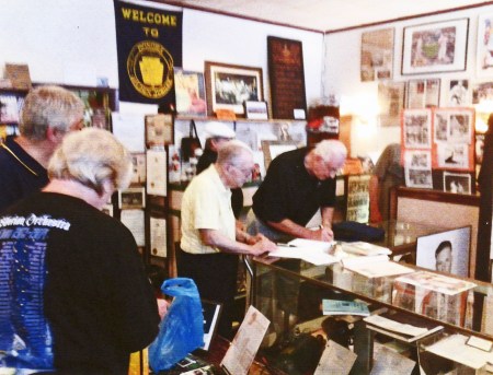 ^'%' Ron Cecciai (black shirt, middle) signs an autograph for Mayor John "Chummy" Lgnelli of Donora, PA yesterday at the Donora (PA) Historical Society. - Photo Contributed by Ron Paglia.