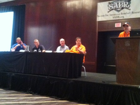 Gilbert Martinez of the Rogers Hornsby Chapter introuuces the College Baseball Panel: (L>R) Roger Clemens, Mike Gustafson, Jim Gilligan, and moderator Mike Vance.