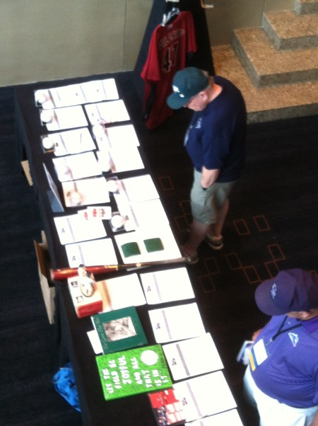 Convention Attendees continue to contemplate a bid or two  at the SABR 44 Silent Auction table.