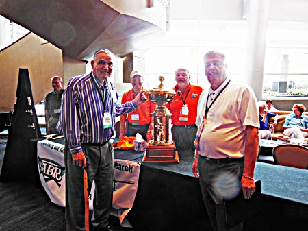 Former Houston Buff Larry Miggins (L) sands beside the 1951 Texas League Championship trophy hat he and his teammates won on yesterday's field of baseball glory.