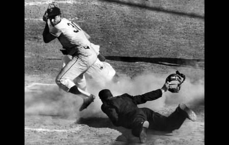 Klem Award for Umpires winner Shag Crawford takes a close look on a safe call at home.