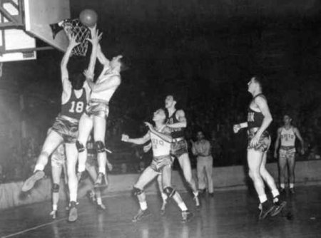 March 27, 1939: Oregon (dark uniforms) fights off Ohio State, 46-33, to become first NCAA college basketball tournament champion.