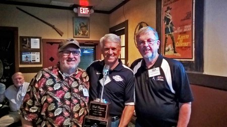 The award was presented by Bill McCurdy (left) and Bob Dorrill (right. The smiling fellow behind the mike in the middle, of course, is again our honoree, Bill Brown. ~ Photo by Bob Dorrill.