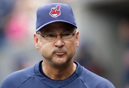 In this photo of Cleveland Indians Manager Terry Francona, can you spot the two things it contains that are potentially bad for baseball and those who play the game?